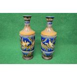 Pair of Doulton Lambeth pottery vases having a blue ground decorated with flowers and having