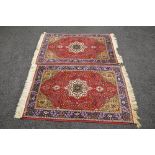 Pair of red ground rugs having blue borders with floral decoration and end tassels - 59" x 39"