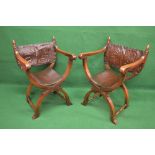 Pair of oak X framed armchairs having embossed leather backs over padded seats on X framed turned