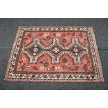 Red ground rug having black and brown pattern with end tassels - 58" x 41"