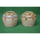 Pair of Royal Doulton Lambeth pottery vases having a grey ground with stylised leaf border and