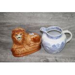 Staffordshire Lion with Glass eyes and a Japanese pattern blue & white transfer decorated jug