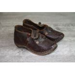 Pair of late 19th century miniature leather clogs with wooden soles, metal buttons and buckles,