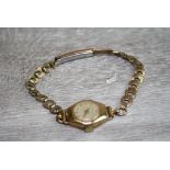 9ct yellow gold cased ladies Walker & Hall wristwatch on gold plated bracelet strap, champagne