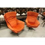 Pair of Retro / Vintage Orange Fabric Upholstered Rotating Armchairs, both raised on Four Metal