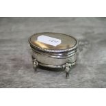Edwardian sIlver ring box modelled as a jewellery casket raised on four feet, oval form with
