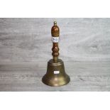 Large Brass Hand Bell with Turned Wooden Handle together with a Brass Temple Style Bell