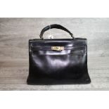 Vintage Hermes Kelly 32 black leather bag, brass hardware, leather interior and zipper pocket,