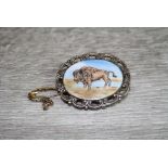 Enamelled silver oval brooch depicting a Buffalo, pierced scroll border surround, makers F C Parry