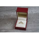 A diamond solitaire 18ct yellow gold ring, the round brilliant cut eight claw set diamond weighing