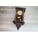 Wooden cased key wind Wall clock with glazed front panel, plays "Auld Lang Syne"