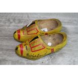 Pair of wooden child's hand painted clogs, dated 'Nederland 1944', length approximately 17.5cm