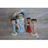 Four boxed Wade ceramic Betty Boop figurines to include a large example, all with COA's