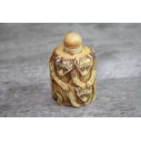 Carved bone snuff bottle depicting monkeys, height approximately 7cm