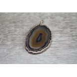 Agate white metal pendant, the oval agate slice with texture naturalistic white metal surround,