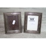 Pair of silver easel back photograph frames, rectangular form with repeated pattern border