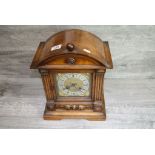Bracket style Wooden cased Mantle clock with German Patent movement, the dial surrounded by winged
