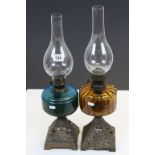 Two 19th Century Oil Lamps with cast Iron bases and coloured glass reservoirs