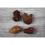 Four miniature wooden netsuke figures to include a fish, goat, hen and monkey