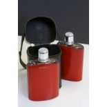 Two Glass Spirit Flasks, each with a Red Leather Cover marked ' Gin ' and ' Whiskey ' contained in a