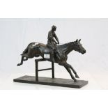 Bronzed resin model of a Jockey & Racehorse clearing a jump, marked to base "O.C.C 2007 699"