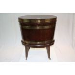 George III Mahogany and Brass Bound Oval Wine Cooler with Hinged Lid, raised on four square tapering