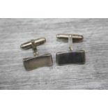 Pair of white metal cufflinks, curved rectangular shaped panels