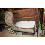 Victorian Mahogany and Cane Rocking Crib with Arched Hood and raised on a turned and square frame,