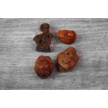 Four miniature wood netsuke figures to include an owl, money giat, bird and another