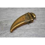 Novelty 20th century brass vesta case in the shape of a tigers claw with a pig to the lid,