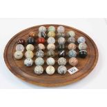 Solitaire game board with 37 gemstone balls