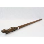 A antique walking stick with carved passant lion handle