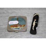 Plastic needle case with black ground and cream decoration, the body depicting a 1920s style woman