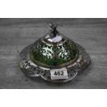 Continental white metal covered Butter dish with Pierced Foliate decoration, Bird finial and a Green