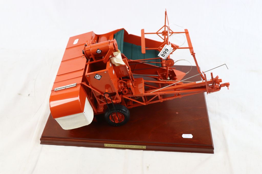 Metal kit built of high standard Allis-Chalmers Type 60A All-Crop Harvester in orange on wooden