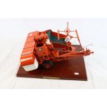 Metal kit built of high standard Allis-Chalmers Type 60A All-Crop Harvester in orange on wooden