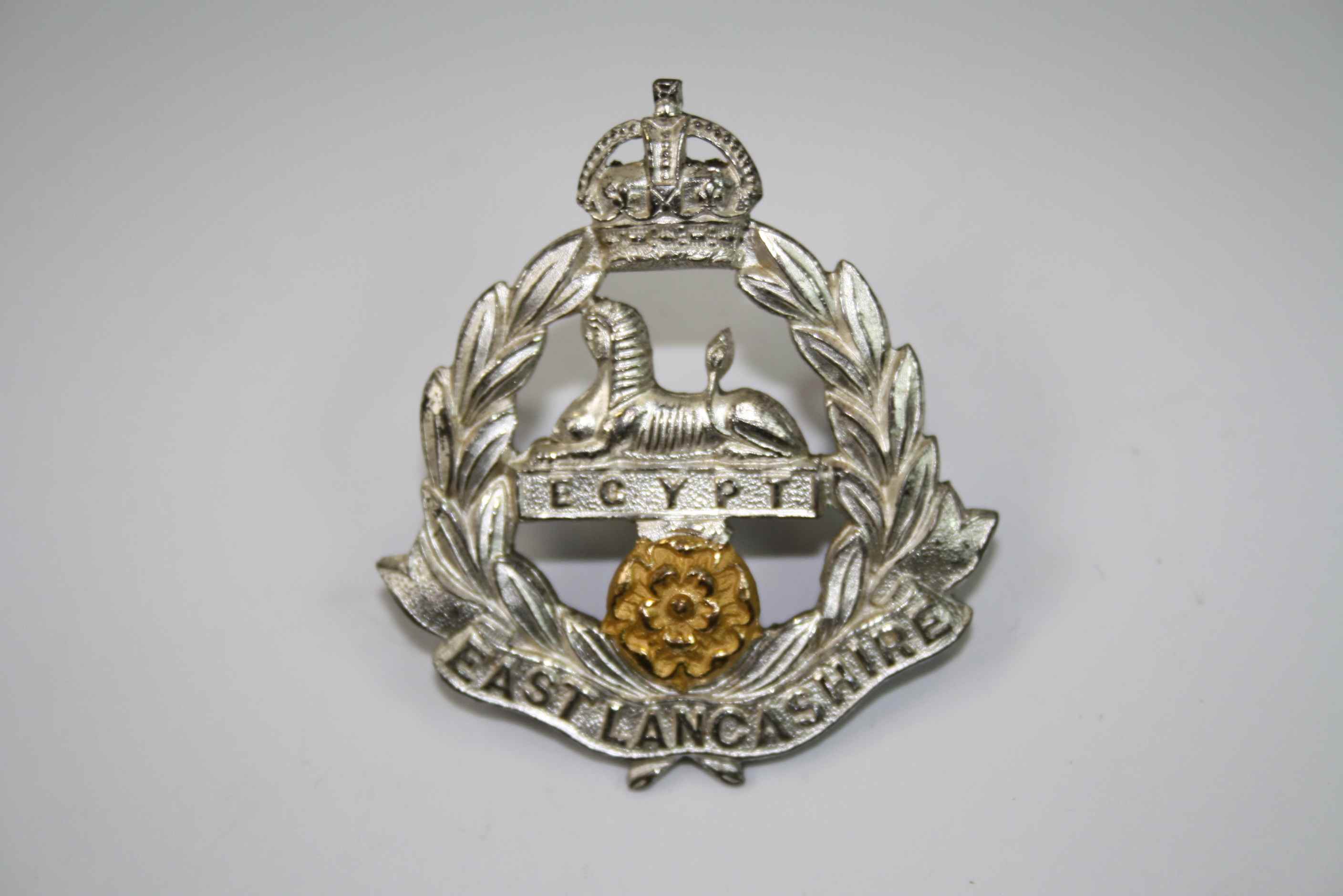 A East Lancashire Regiment Officers Silver Gilt Plated Cap Badge With Rear Lug Fixings And Maker