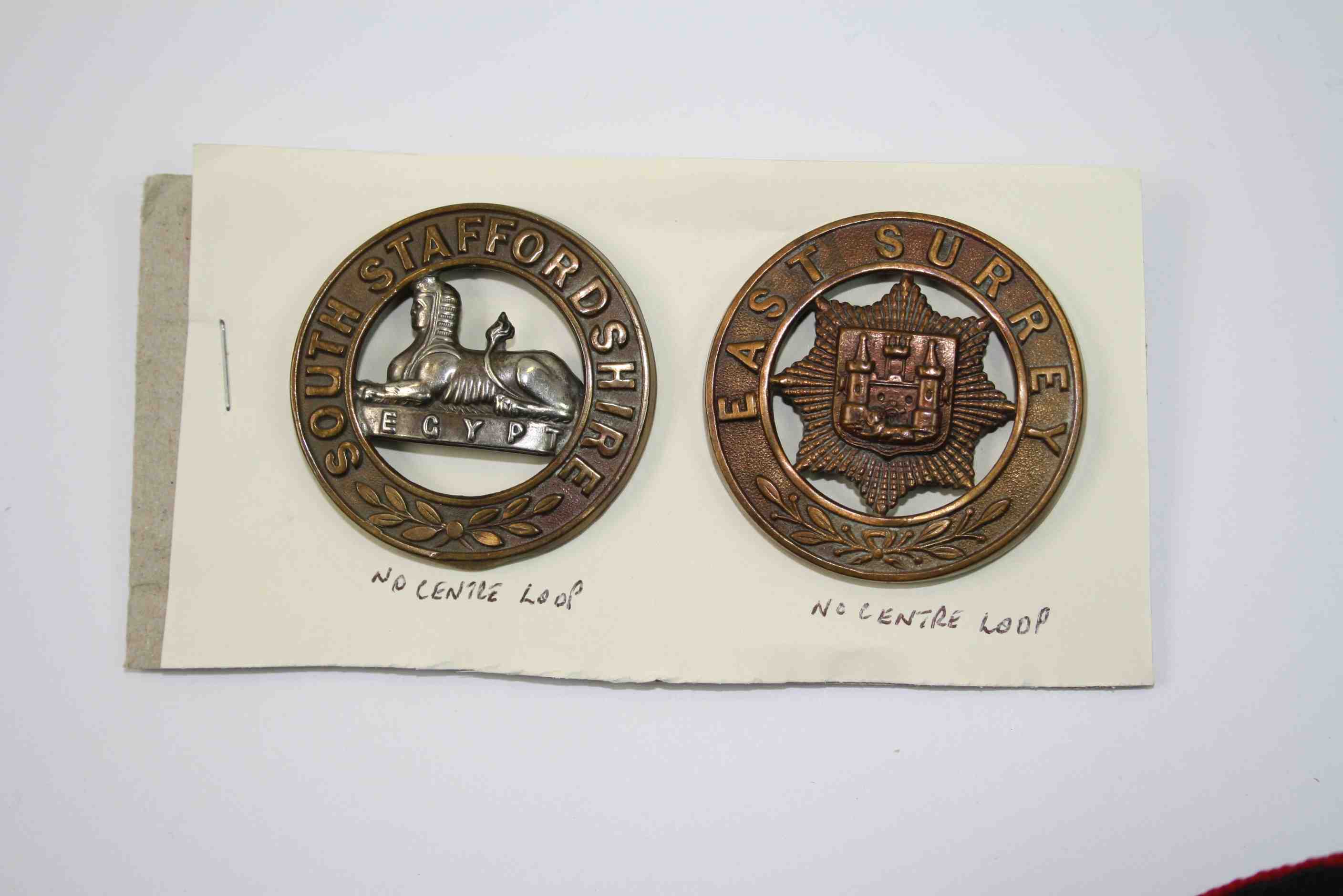 Two Brass Helmet Plate Badges For The South Staffordshire And The East Surrey Regiments.