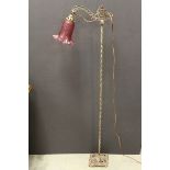 Early 20th century Ornate Metal Standard Reading Lamp with a Cranberry Glass Shade and another