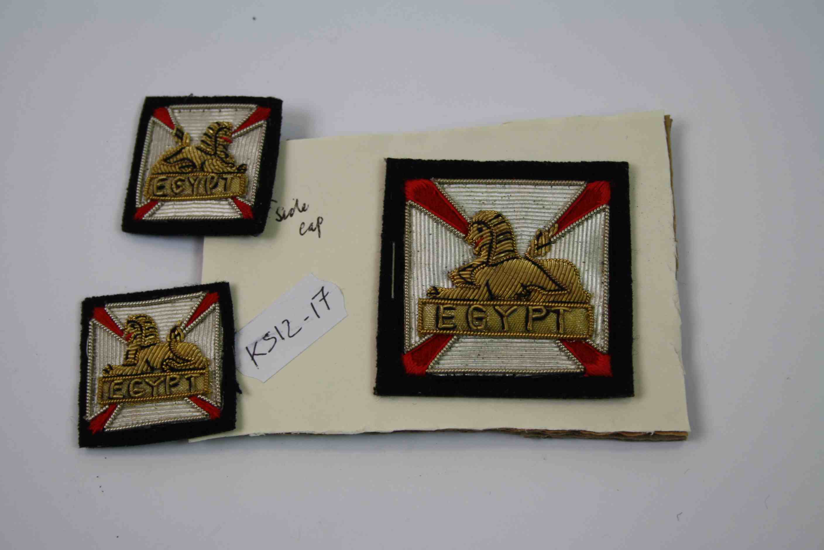 A Gloucestershire Regiment Side Cap Cloth Badge Together With Two Mess Collar Badges.