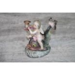 Continental hand painted figure group depicting cherub with cornucopia horn sat on a mythical