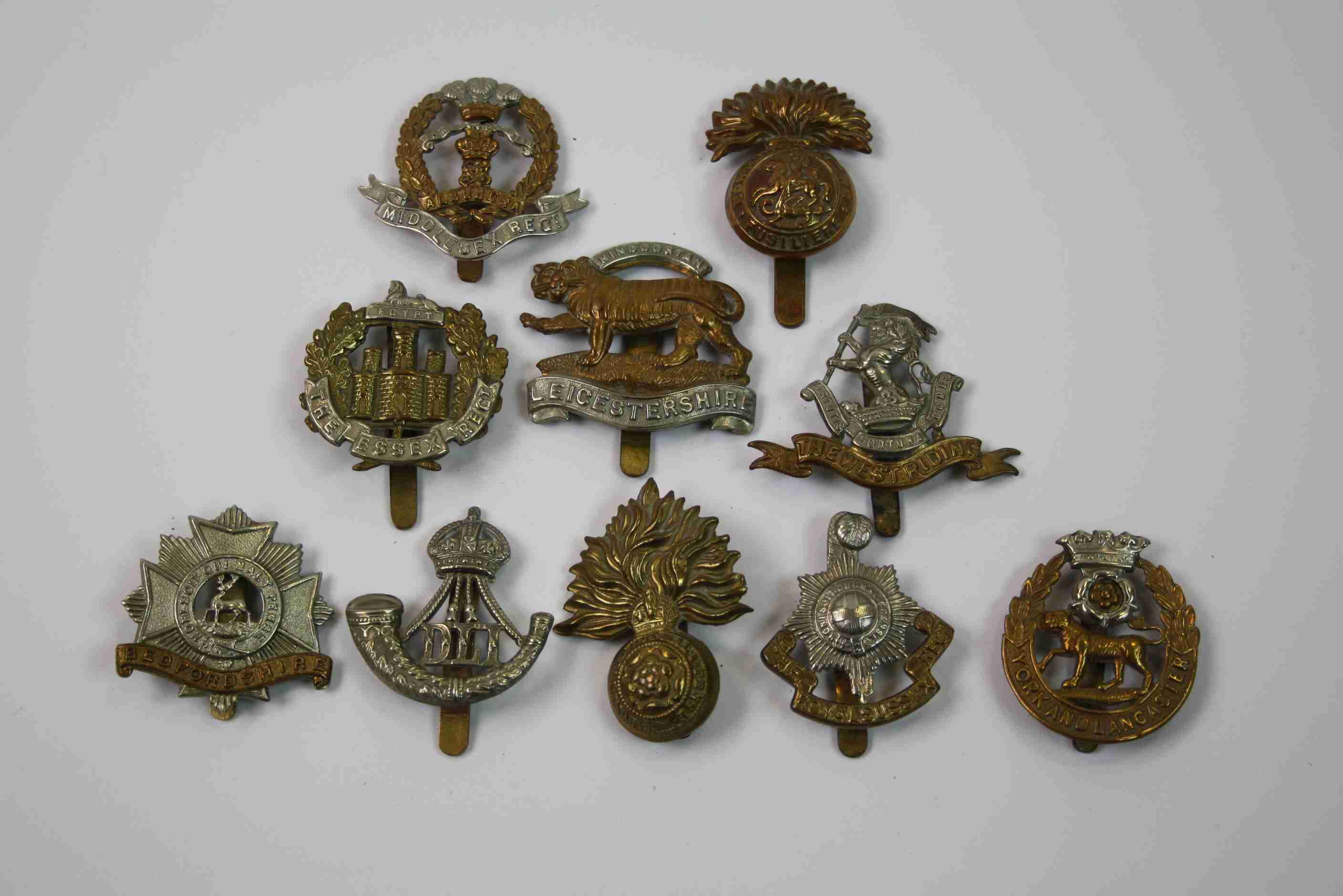 A Collection Of Ten British Military Regimental Cap Badges To Include : Middlesex Regiment, York And