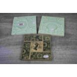 Pair of Art Nouveau square tiles, depicting stylised fish in relief, tails raised and crossed,