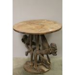 African / Ethnic Hardwood Table, the circular top held by two carved Tribal Figures bending over,