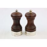 Turned wood and silver salt and pepper grinders of baluster form, silver collars and finials, makers