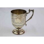 Mid Victorian silver pedestal mug, the body with engraved Greek Key and foliate scroll designs,