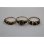 Three gem set 9ct yellow gold rings comprising amethyst seven stone 9ct yellow gold ring, seven