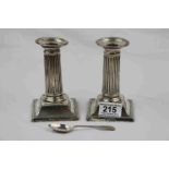 Pair of silver dwarf Corinthian column candlesticks raised on square moulded bases, ribbed stems,