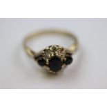 Sapphire and diamond flower head cluster 9ct yellow and white gold set ring, the central oval