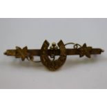 Victorian 9ct yellow gold sweetheart horseshoe bar bar brooch, the horseshoe with floral and foliate
